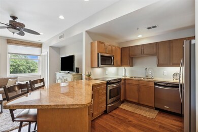 Kitchen featuring ceiling fan, sink, light stone c