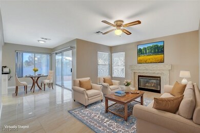 Living room with a ceiling fan, visible vents, bas
