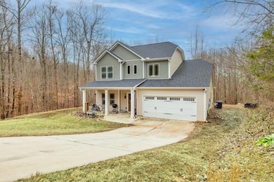 Traditional-style home with a porch, driveway, an 