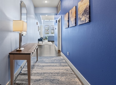Long entry hall with gallery walls welcome you
