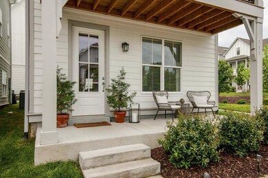 Cozy covered front porch, perfect for morning coffee or entertaining!
