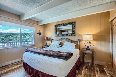 Bedroom featuring a textured ceiling, hardwood / w