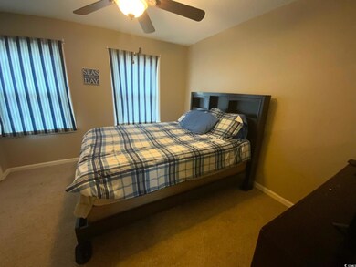 Bedroom featuring carpet flooring and ceiling fan