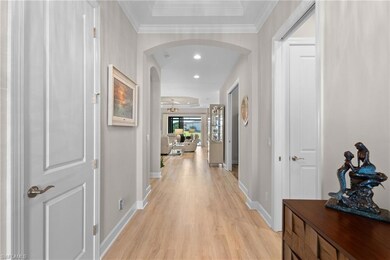 Hallway with ornamental molding and light wood-typ