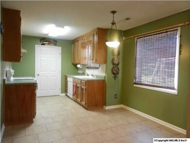 Kitchen features ceramic tile and fresh paint.