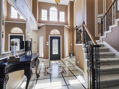The front entry is inviting with marble and wood flooring.