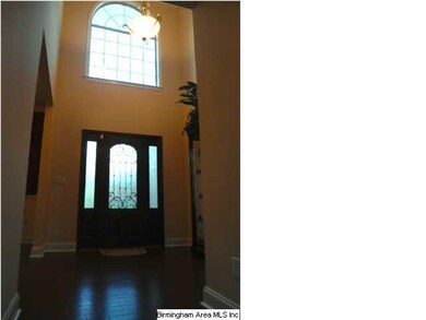 2-story foyer with beautiful hardwood flooring wel