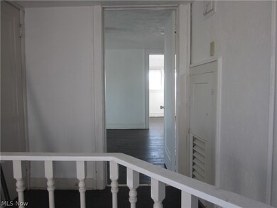 Corridor with dark hardwood / wood-style floors