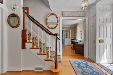 Entryway with ornamental molding, wood finished fl