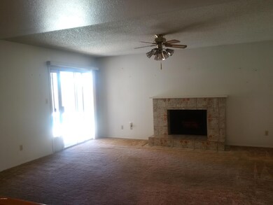 Family with wood fireplace off kitchen
