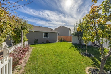 Fenced backyard featuring a storage unit