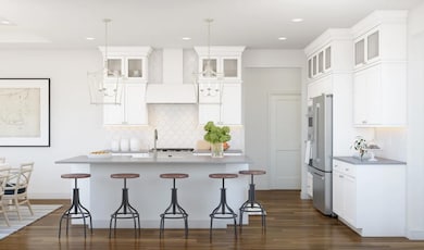 Kitchen with glass upper cabinets and pendant lighting