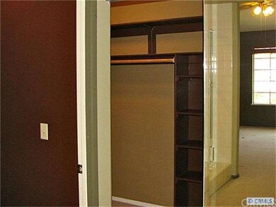Large walk in master closet with mirrored doors