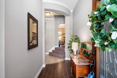 Enter through the leaded glass front door to wood-look tile floors.