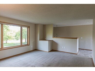 The living room has a big picture window, looking 