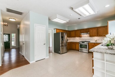 The hallway from the two-story foyer leads past th