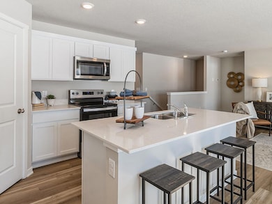 Kitchen with walk-in pantry and stainless-steel appliances.