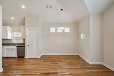 Dining area features lots of natural light and high ceilings.