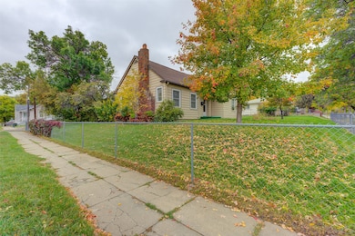 View of front of property with a chimney and a fenced backyard