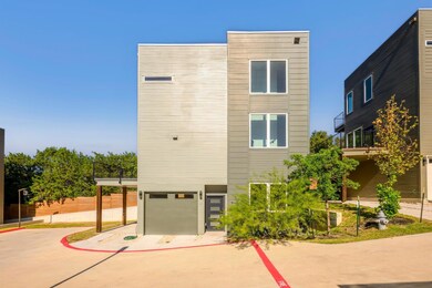 View of front of house featuring concrete driveway and an attached garage