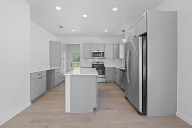 Kitchen with stainless steel appliances, gray cab