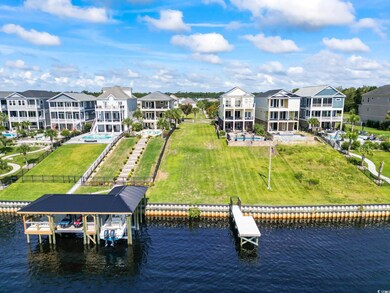 View of dock featuring a lawn and a water view