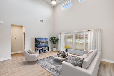 Living room with french doors, visible vents, bas