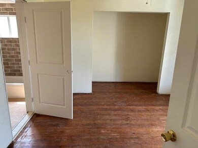 Corridor featuring dark hardwood / wood-style floo