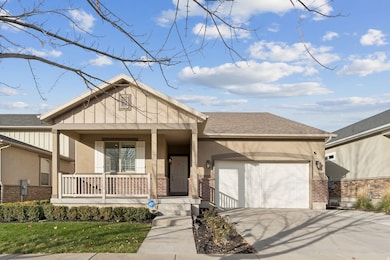 View of front of home with covered porch, brick siding, driveway, and a shingled roof