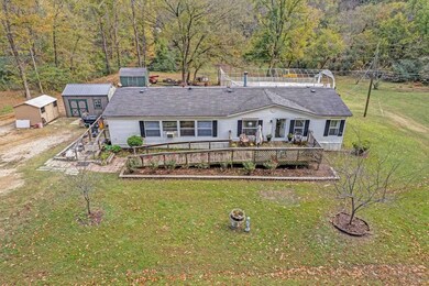 Front of property featuring a wooden deck, a yard,