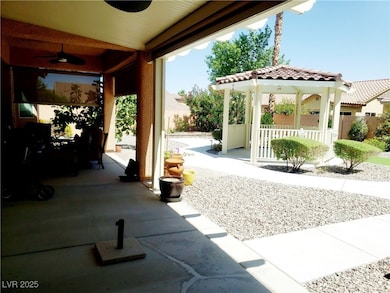 View of patio with a ceiling fan and a gazebo