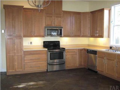 Updated wood cabinets with brushed hardware