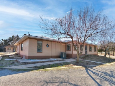 View of front of property with central AC unit