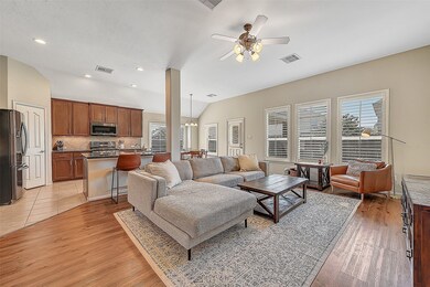Open and spacious family room with large windows, plantation shutters, and fabulous views of the backyard.