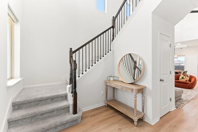 Staircase featuring wood finished floors, a tower
