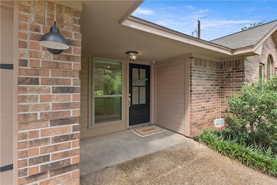 View of exterior entry with brick siding