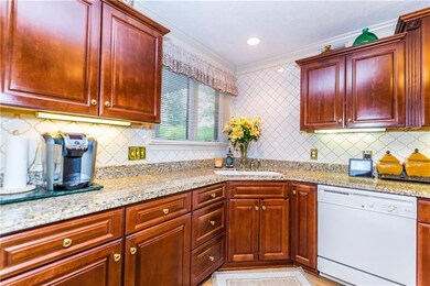 The kitchen with granite counter tops is enhanced 