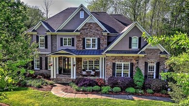 Full brick, stone and cedar home with front porch 
