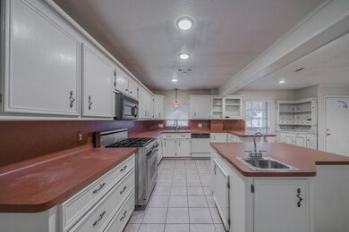 Kitchen has Gas Range, 2 Sinks & Recessed Lighting.