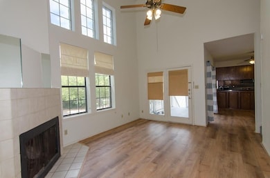Unfurnished living room featuring a ceiling fan, 