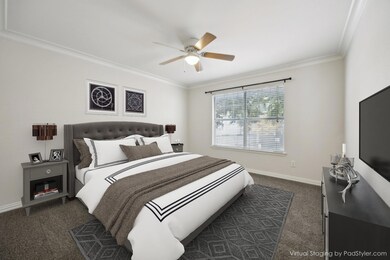 Bedroom featuring ceiling fan, dark carpet, and cr