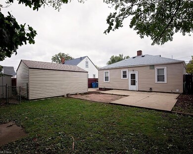 Back of property featuring a yard and a patio