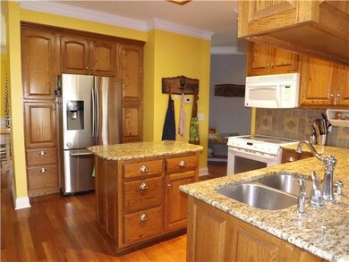 This great kitchen has custom cabinetry with pantry, numerous pull out drawers, center island and breakfast bar. 