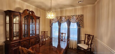 Formal Dining Room with chair rail molding and cro