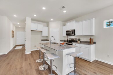 Kitchen featuring white cabinets, appliances with 