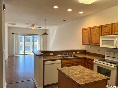 Kitchen with white appliances, decorative light fi