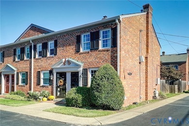 Colonial-style house with brick siding