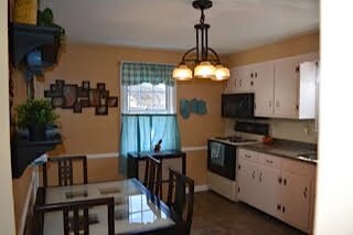 Kitchen with freshly painted cabinets and dining a