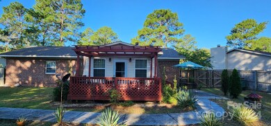 Backyard view of pergola on a raised deck.