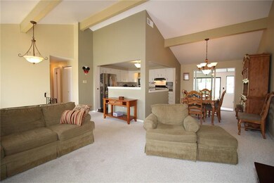 THE VAULTED CEILING AND OPEN KITCHEN GIVE THIS A M